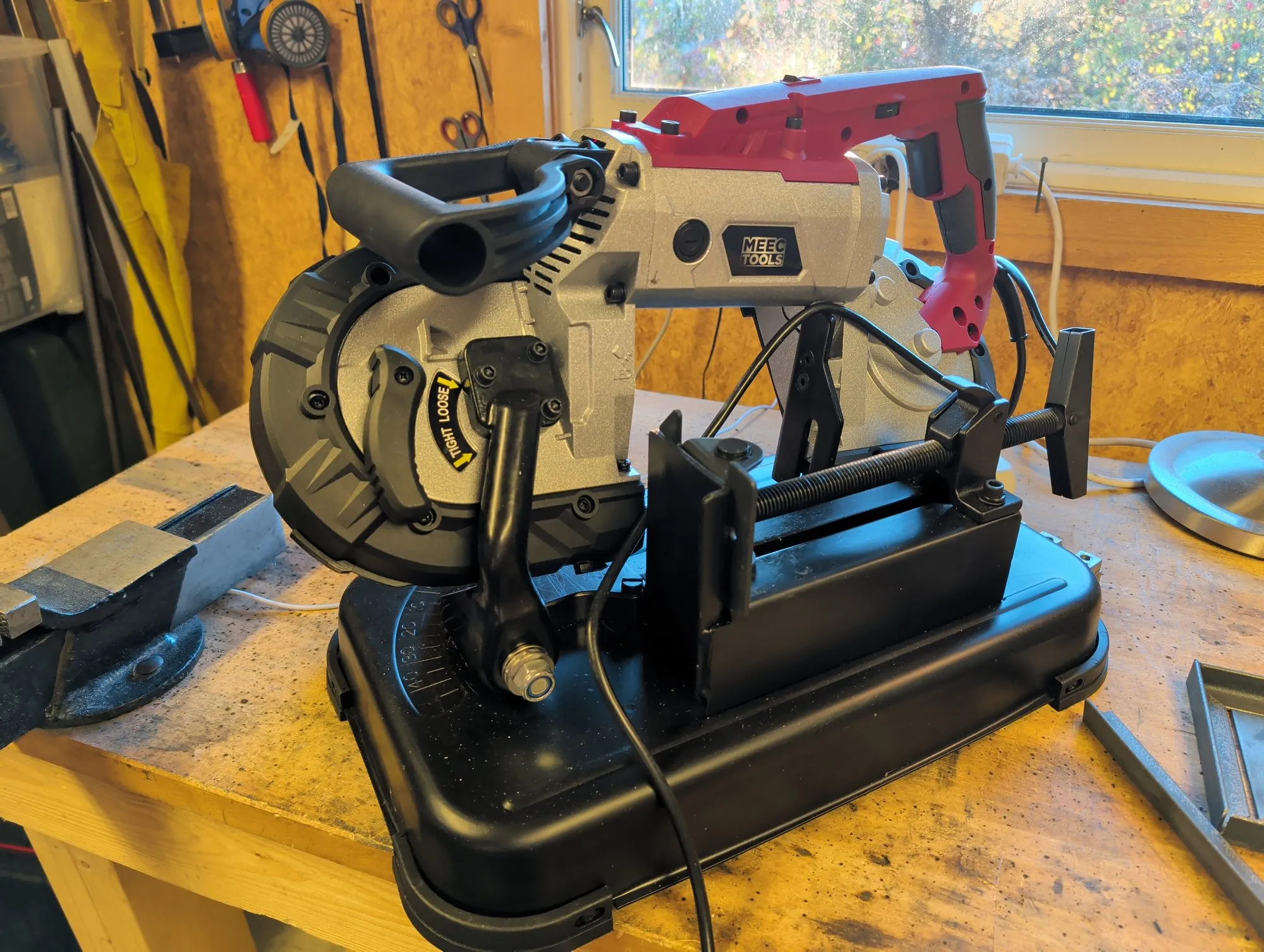 The Meec Tools band saw on the workbench, with its vice and black base